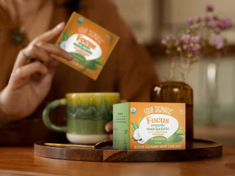 How to Use: Four Sigmatic Matcha Latte packet being mixed in a mug.