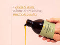 Fushi Organic Black Seed Oil 100 ml oil being poured onto hand during application