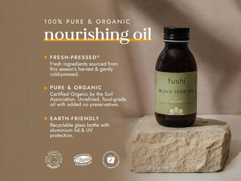 Fushi Organic Black Seed Oil 100 ml bottle on brown background with label close up
