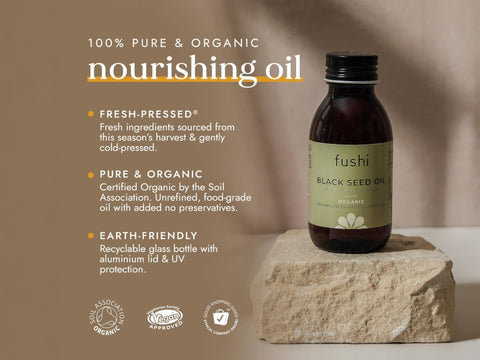 Fushi Organic Black Seed Oil 250 ml bottle on brown background with label close up
