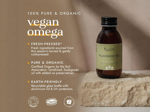 Fushi Organic Flaxseed Oil 100 ml bottle on brown background with label close up