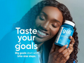 Woman holding a goli supplement bottle with text about tasting goals and steps.