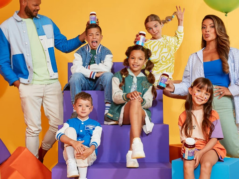Family with children on colorful steps against a yellow background