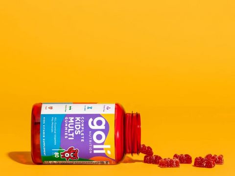 Red Goli Kids Multi supplement bottle with gummy bears on a yellow background