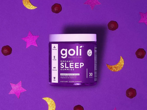 Goli Dreamy Sleep gummies container on a purple background with star and moon decorations