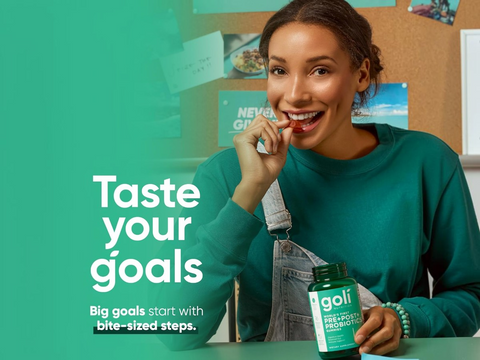 Woman holding a Goli probiotic bottle with text 'Taste your goals' on a green background