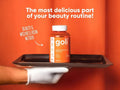 Goli supplement bottle on a tray with text about beauty routine against an orange background