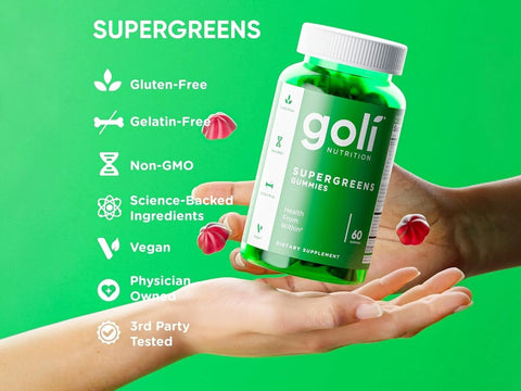 Goli SuperGreens gummy bottle held in a hand with green background and feature list.