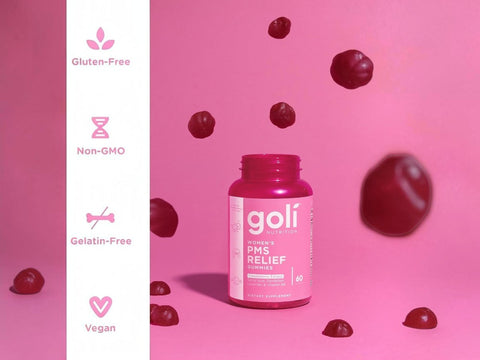 Goli PMS Relief supplement bottle on a pink background with cranberries