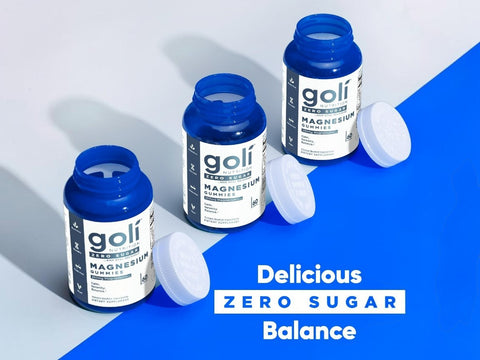 Three bottles of goli magnesium supplement on a blue and gray background with text 'Delicious Zero Sugar Balance'.