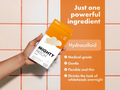Hand holding Mighty Patch packaging with product details on an orange background