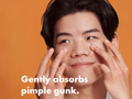 Person applying a skincare product with text 'Gently absorbs pimple gunk' on an orange background