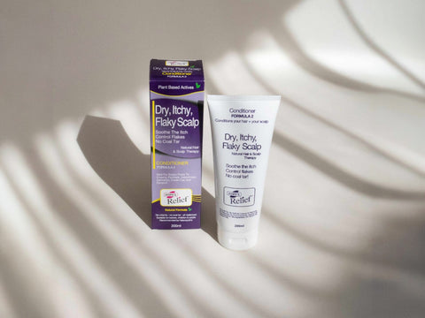 Two scalp care products on a light background with shadow