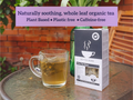 Tea cup with tea leaves and a box of tea on a table outdoors, with promotional text overlay.
