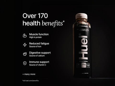 Huel chocolate protein bottle with health benefits listed on a black background