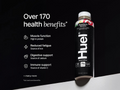 Huel protein bottle with health benefits listed on a black background