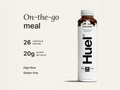 Huel chocolate protein shake bottle with nutritional information on a light beige background