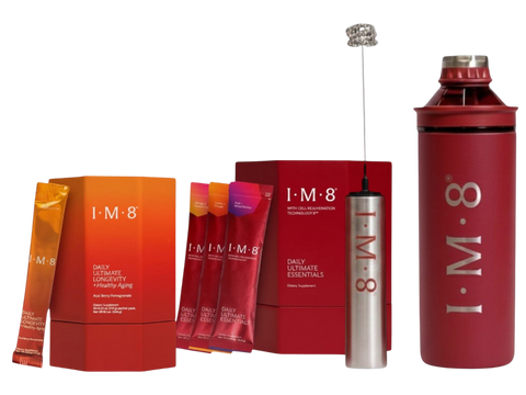 A 1-M-8 Daily Ultimate Vitality drink mix kit on a white background, featuring a large red shaker bottle, a red carton, several orange-to-red gradient sachets, and a silver frother.