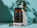 Brown bottle labeled 'Cognitive' by Kiki Health on a stone surface with greenery