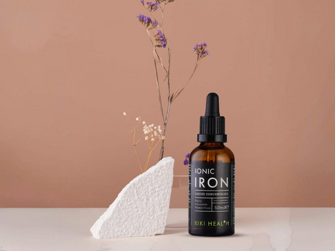 Bottle of Ionic Iron supplement with a dropper on a neutral background