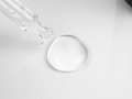 Close-up of a clear droplet on a white background