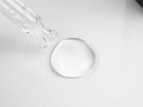 Close-up of a clear droplet on a white background
