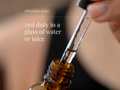 Close-up of a dropper with liquid and text on directions of use.