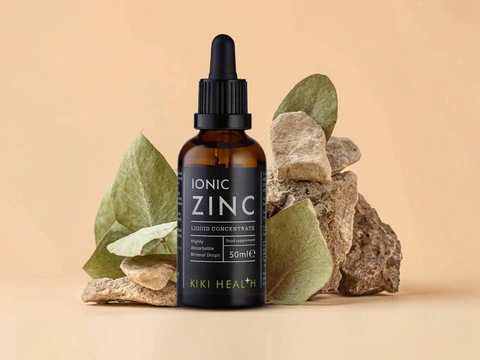 KIKI Health Ionic Zinc liquid concentrate bottle with dropper on a beige background with rocks and leaves.