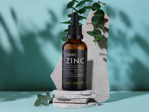 Bottle of KIKI Health Ionic Zinc on a stone surface with greenery