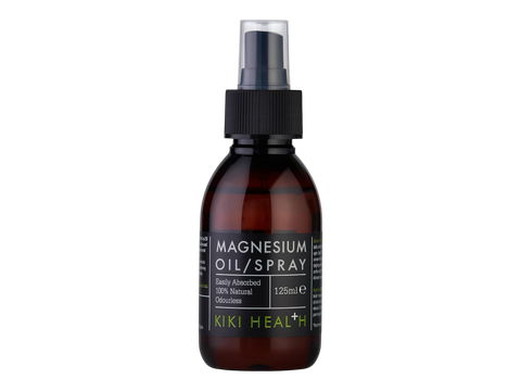 Brown bottle of magnesium oil spray with black cap on a white background