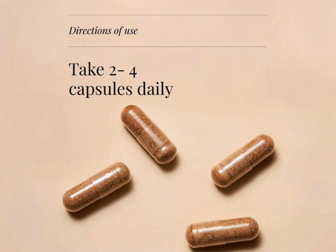Four capsules on a beige background with text indicating daily dosage.