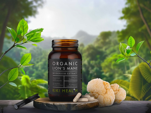 Bottle of Organic Lion's Mane Mushroom Extract by KIKI Health with green leaves and a forest background
