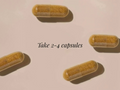 Four capsules on a light pink background with text 'Take 2-4 capsules'.