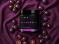 Kaged pre-workout supplement container surrounded by grapes on a purple fabric background