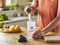 How to Use: Shaker bottle with Myprotein Clear Whey Isolate powder pouring.