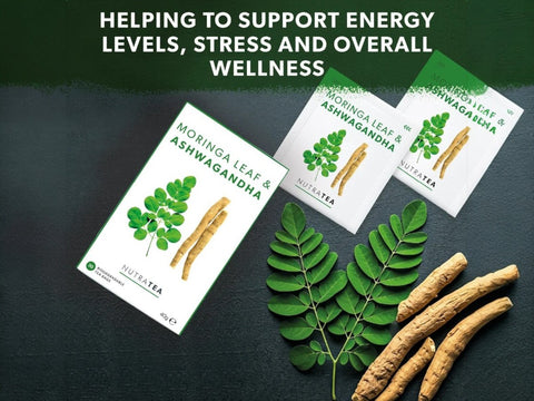 Moringa Leaf Ashwagandha tea packages with leaves and roots on a dark surface, promoting energy levels and wellness.