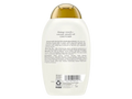 Back view of a bottle of OGX Damage Remedy + Coconut Miracle Oil Conditioner on a white background