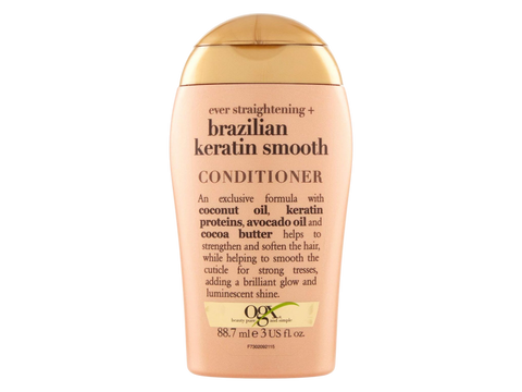 Conditioner bottle with gold cap and beige body on a white background