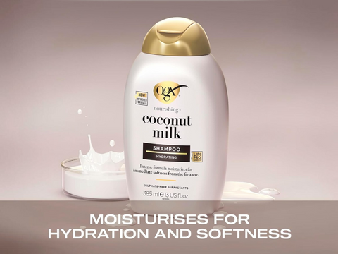OGX coconut milk shampoo bottle with a splash of product on a beige background