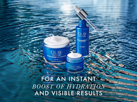 Olay skincare products with water droplet on a blue water background