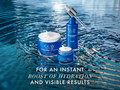Olay skincare products with water dropper on a water surface