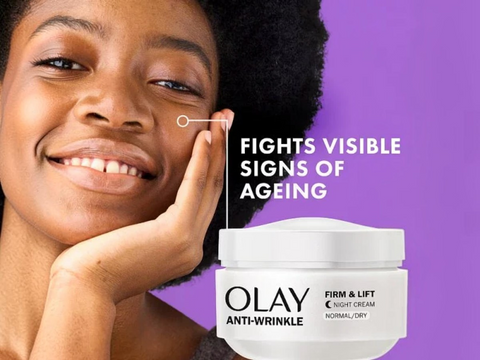Woman applying Olay anti-wrinkle cream with text highlighting age-fighting properties on a purple background