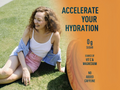 Woman sitting on grass with a product container labeled 'Accelerate Your Hydration' on an orange background.