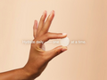 Hand holding a small white object against a beige background with text overlay.
