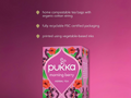 Pukka morning berry herbal tea packaging on a pink background with sustainability information.