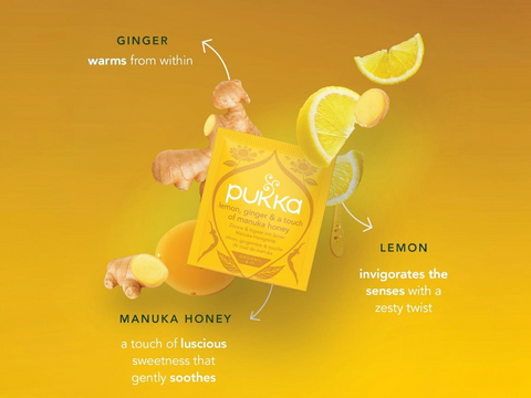 Pukka tea packaging with ginger, lemon, and manuka honey on a yellow background
