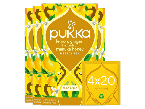 Pukka lemon, ginger, and manuka honey herbal tea packaging on a white background
