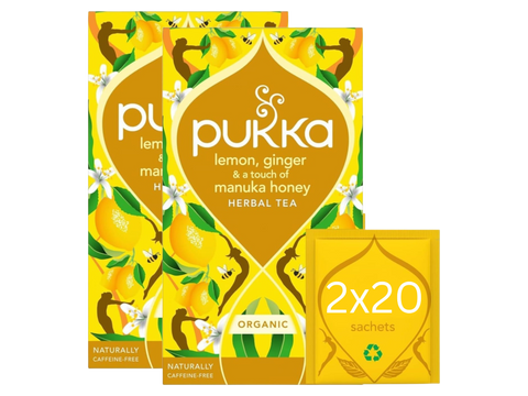 Pukka lemon, ginger, and manuka honey herbal tea packaging on a white background