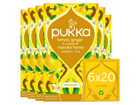 Pukka lemon, ginger, and manuka honey herbal tea packaging on a white background