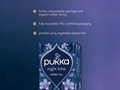 Pukka night time herbal tea packaging with sustainability features on a blue background